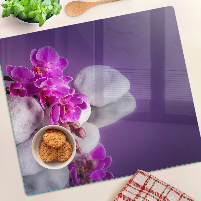 Deska kuchenna szklana Kwiaty orchidei na tle kamieni