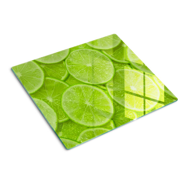 Szklana deska kuchenna Plastry limonki na zielonym tle