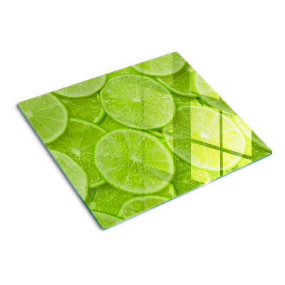 Szklana deska kuchenna Plastry limonki na zielonym tle