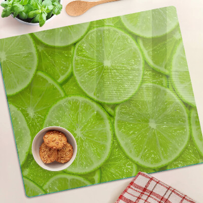 Szklana deska kuchenna Plastry limonki na zielonym tle