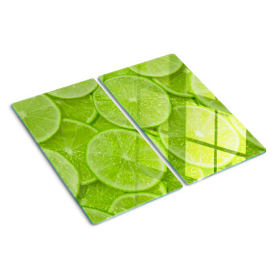 Szklana deska kuchenna Plastry limonki na zielonym tle
