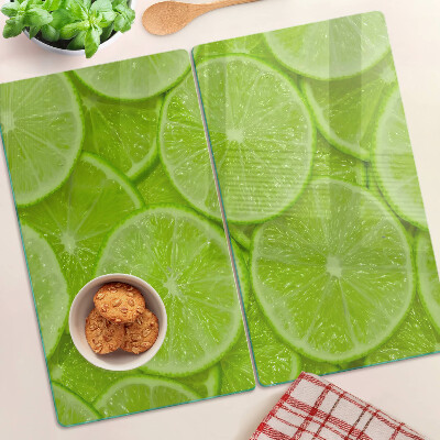 Szklana deska kuchenna Plastry limonki na zielonym tle