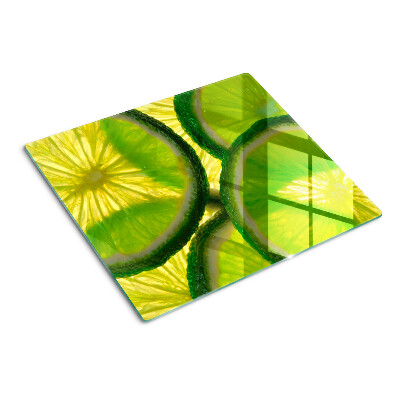 Szklana deska do krojenia Plastry limonki na zielonym tle