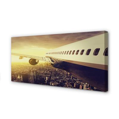 Obraz na płótnie Samolot nad Wieczornym Miastem