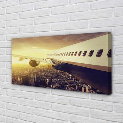 Obraz na płótnie Samolot nad Wieczornym Miastem