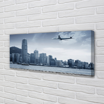 Obraz na płótnie Samolot miasto chmury