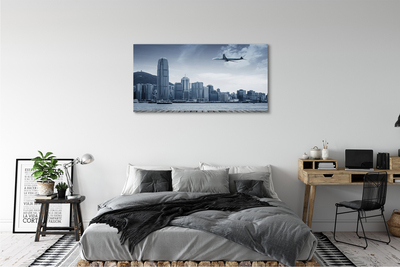 Obraz na płótnie Samolot miasto chmury