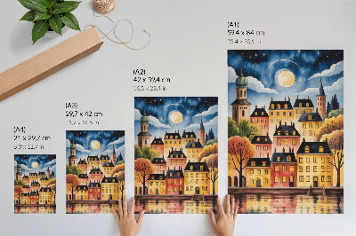 Plakat na płótnie Klimatyczne miasto nocą z księżycem na niebie